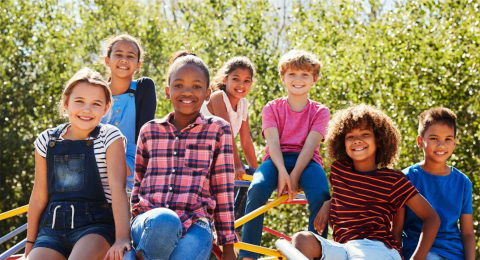 Smiling children in front of trees